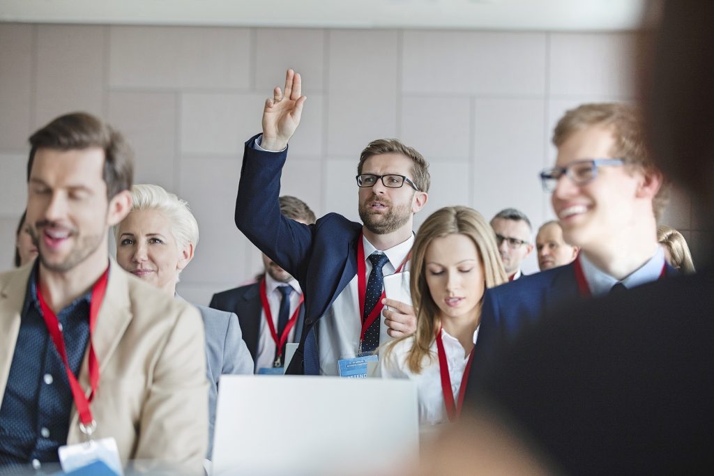Corporate away days - Businessman asking questions during seminar